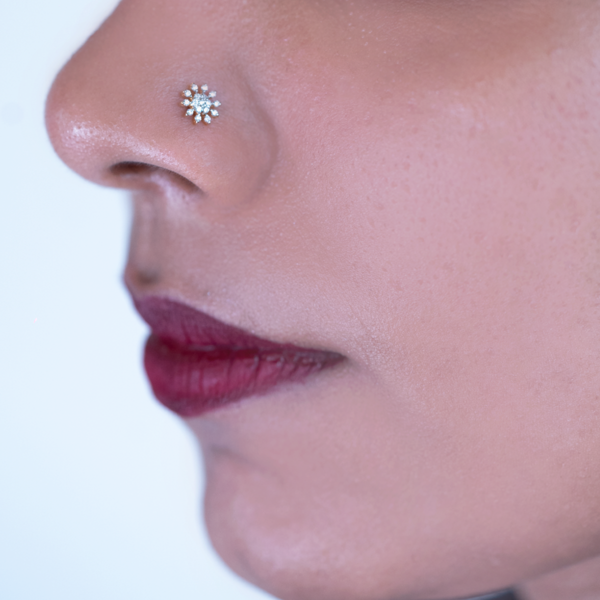 model wearing Damaru's floral design diamond nose pin.