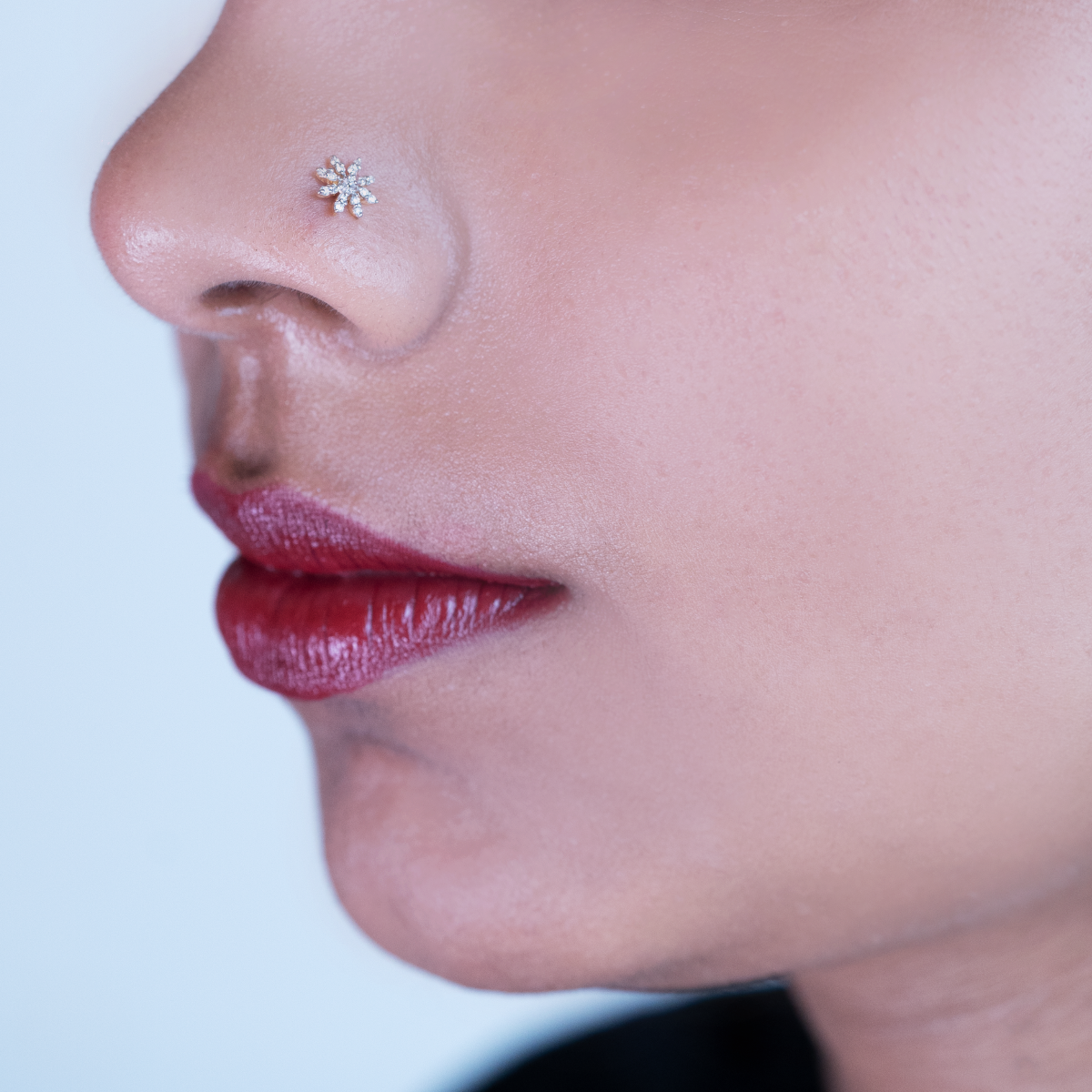 model wearing floral shaped diamond nose pin