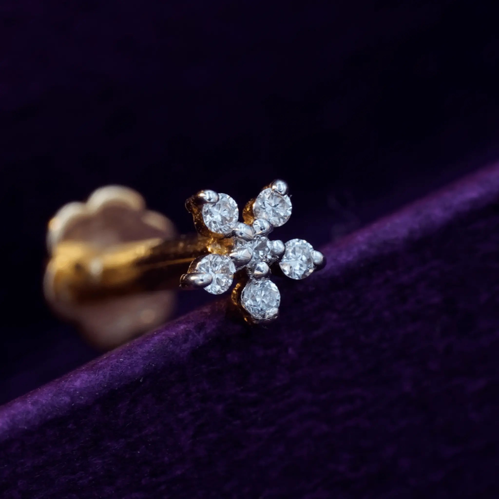 Six-stone round diamond nose pin in 18K gold.