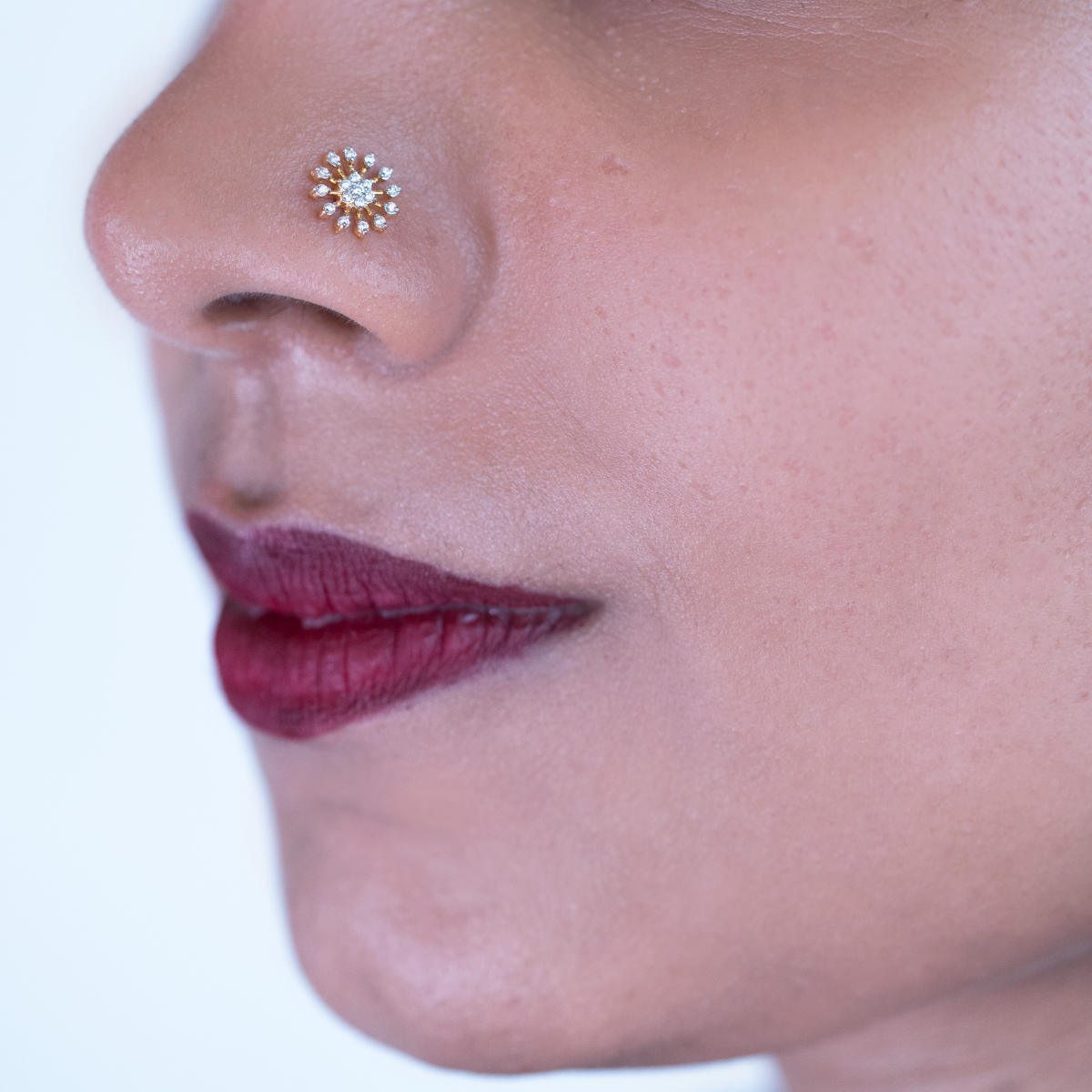 model wearing damaru's floral shaped diamond nose pin 