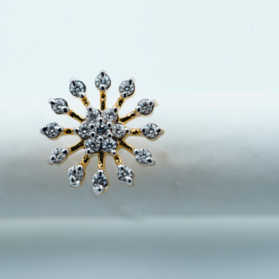A beautiful sun shaped diamond nose pin for women image in a white background.