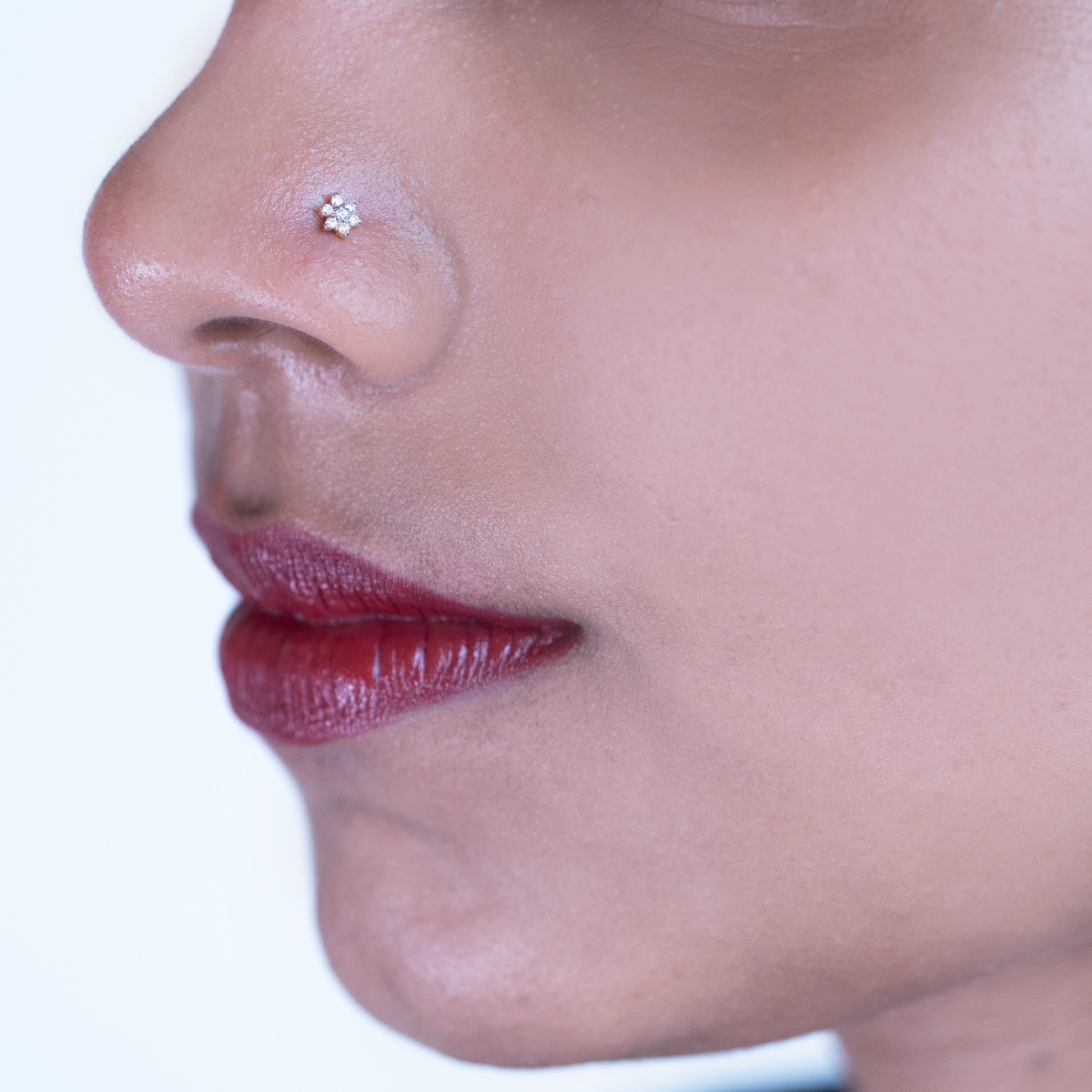 model wearing simple diamond nose pin