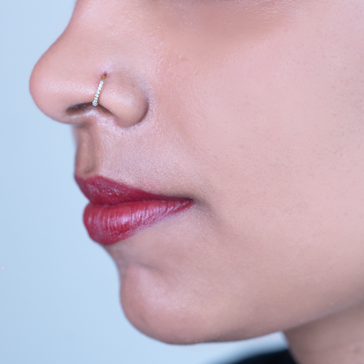 model wearing ring diamond nose pin 