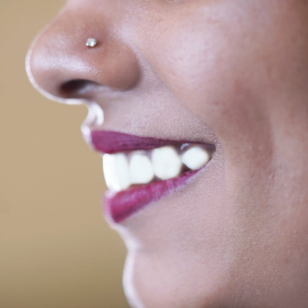 model wearing damaru's single stone diamond nose pin. 